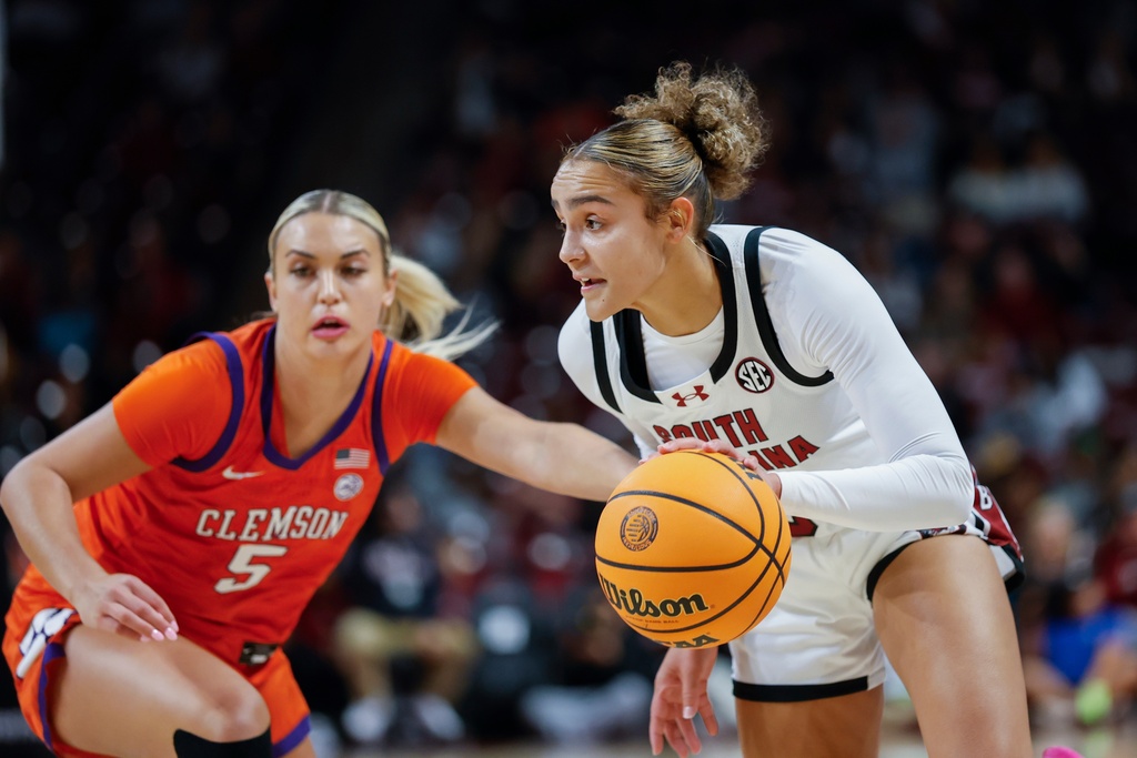 South Carolina guard Tessa Johnson, right, drives against Clemson guard Hannah Kohn during the first half of an NCAA college basketball game in Columbia, S.C., Tuesday, Nov. 11, 2025. (AP Photo/Nell Redmond)