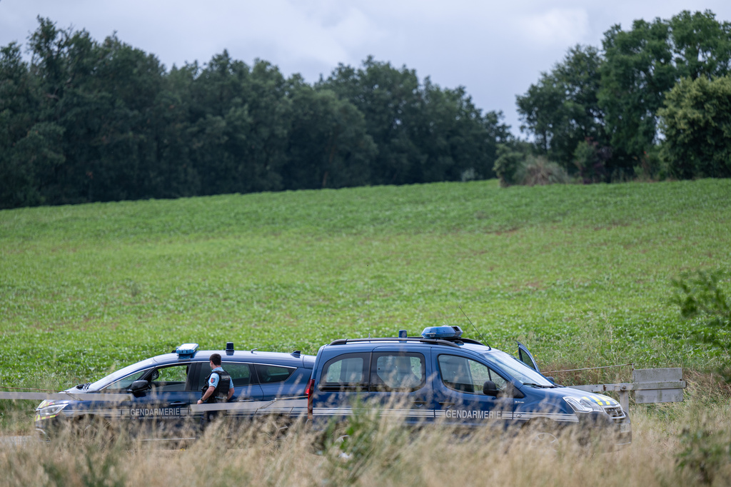 French police block the road near a farm silo where a body was found yesterday during the search to find missing 11 year-old girl Lyhanna in Puycasquier, southwestern France, Friday, June,5, 2026. (AP Photo/Frederic Lancelot)