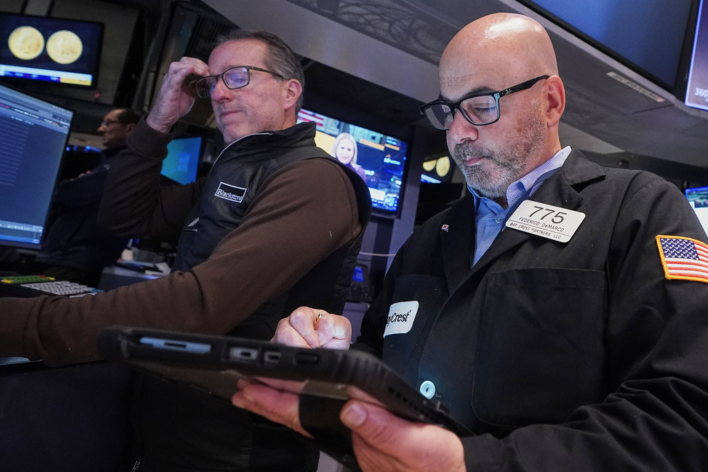 Specialist Glenn Carell, left, and trader Fred Demarco work on the floor of the New York Stock Exchange, Tuesday, Nov. 18, 2025. (AP Photo/Richard Drew)
