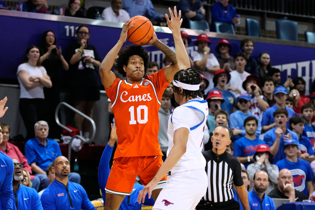 Miami guard Tru Washington (10) shoots as SMU's Jermaine O'Neal Jr. defends in the first half of an NCAA college basketball game in Dallas, Wednesday, March 4, 2026. (AP Photo/Tony Gutierrez)