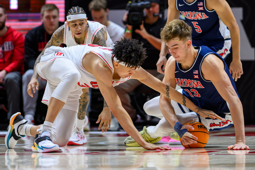 Arizona center Motiejus Krivas, front right, and Utah forward James Okonkwo, front left, battle for possession of the loose during the second half of an NCAA college basketball game, Saturday, Jan. 3, 2026, in Salt Lake City. (AP Photo/Tyler Tate)