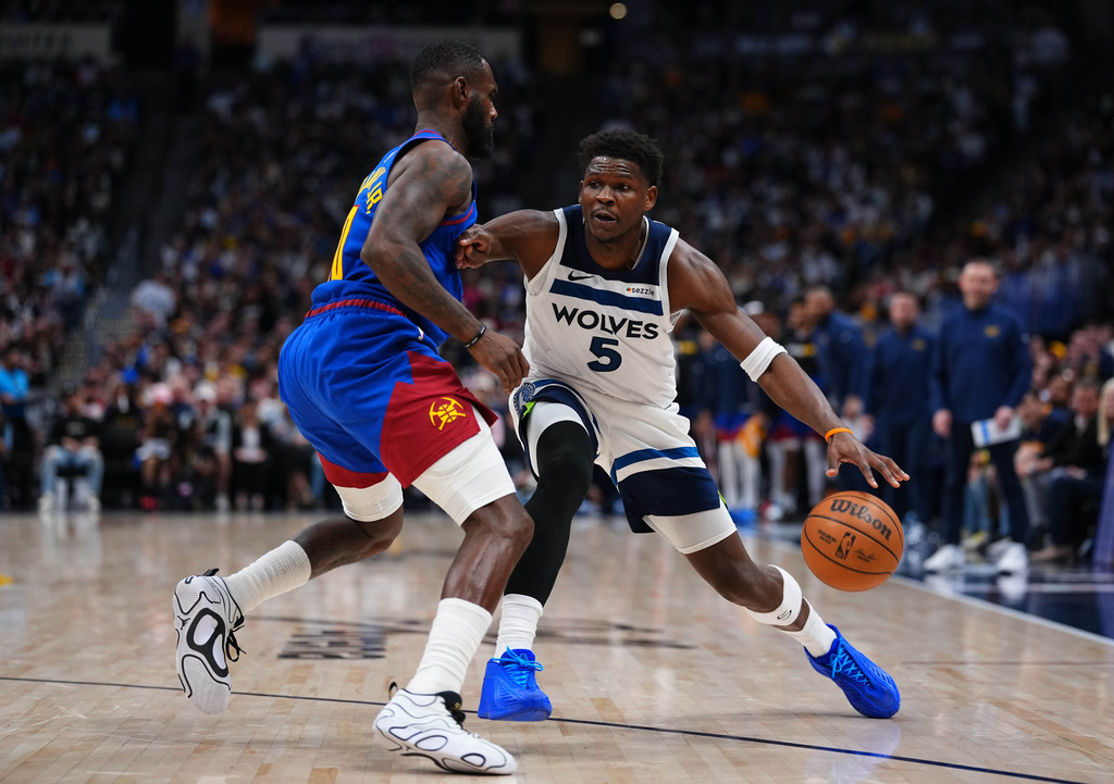 Minnesota Timberwolves guard Anthony Edwards (5) drives to the basket against Denver Nuggets guard Tim Hardaway Jr. (10) during the second half in Game 2 of a first-round NBA playoffs basketball series Monday, April 20, 2026, in Denver. (AP Photo/Jack Dempsey)