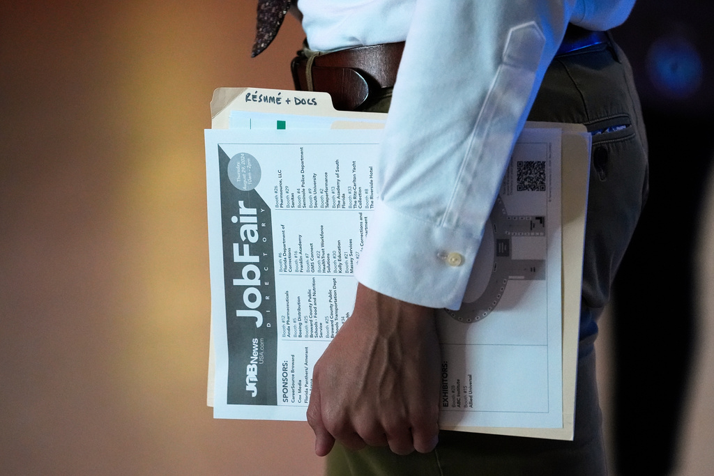 FILE - A person waits in a line for a prospective employer at a job fair, Aug. 29, 2024, in Sunrise, Fla. (AP Photo/Lynne Sladky, File)