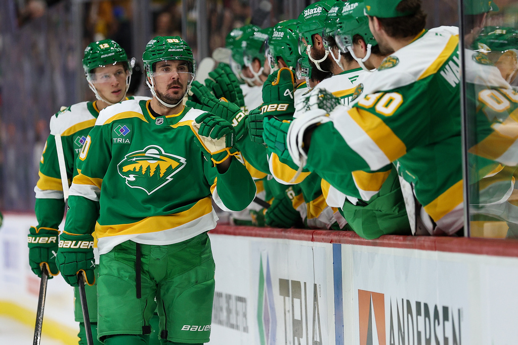 Minnesota Wild left wing Marcus Johansson (90) celebrates his goal with teammates during the third period of an NHL hockey game against the Dallas Stars Thursday, Dec. 11, 2025, in St. Paul, Minn. (AP Photo/Matt Krohn)