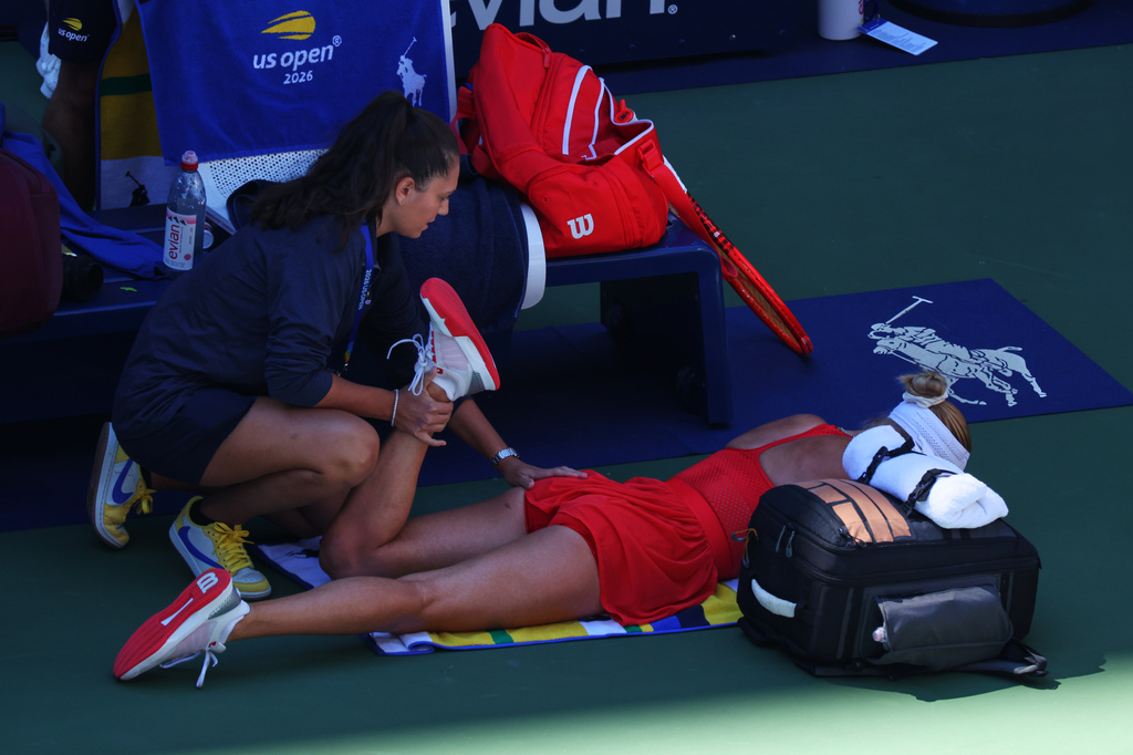 Anastasia Potapova, of Austria, has her leg worked on during a medical timeout during a match against Mirra Andreeva, of Russia, during the fourth round of the U.S. Open tennis championships, Monday, Sept. 7, 2026, in New York. (AP Photo/Andres Kudacki)