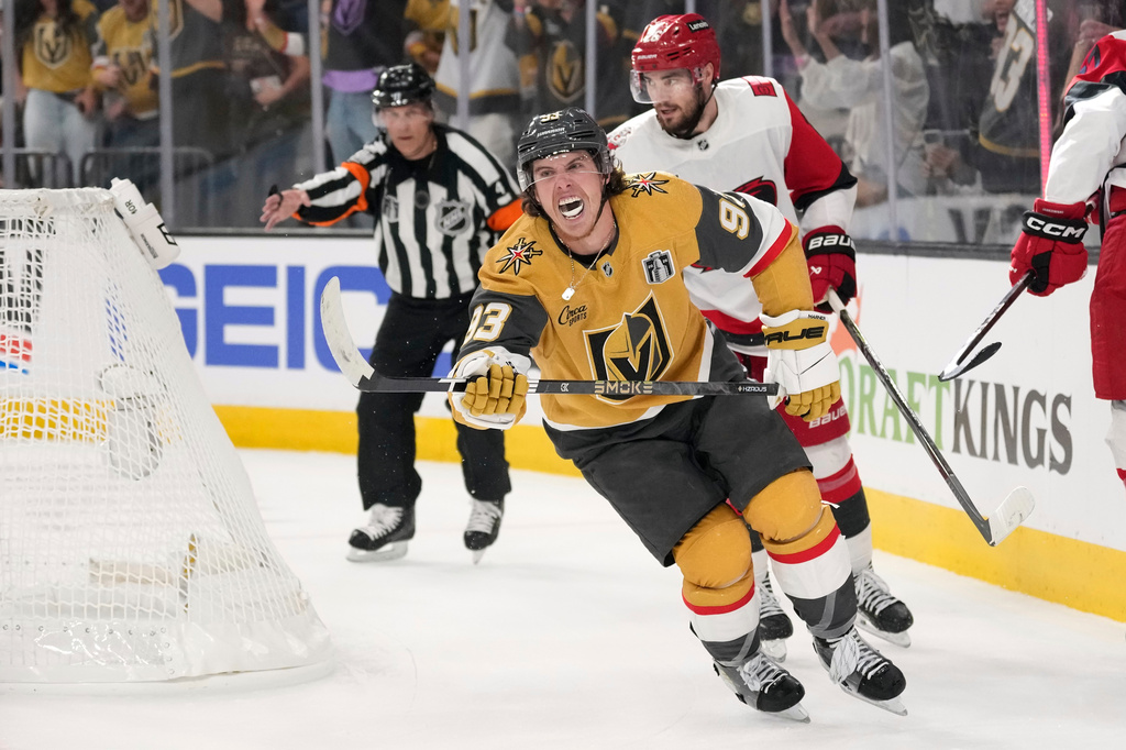Vegas Golden Knights right wing Mitch Marner, left, celebrates his goal as Carolina Hurricanes defenseman Sean Walker, right, skates behind during the second period in Game 3 of the NHL hockey Stanley Cup Final series, Saturday, June 6, 2026, in Las Vegas. (AP Photo/John Locher)