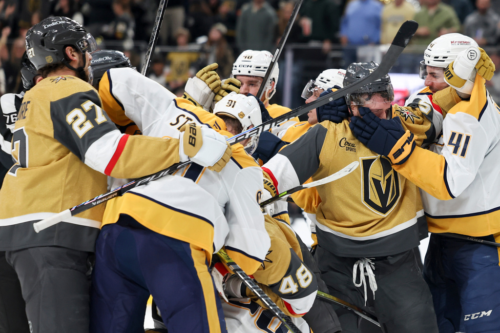 Vegas Golden Knights defenseman Jeremy Lauzon (5) and Nashville Predators defenseman Nicolas Hague (41) fight during the second period of an NHL hockey game Saturday, Jan. 17, 2026, in Las Vegas. (AP Photo/Ian Maule)