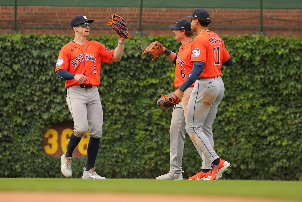 Houston Astros' Zach Cole, left, Jake Meyers, middle, and Cam Smith, right, celebrate after a baseball game against the Chicago Cubs on Friday, May 22, 2026, in Chicago. (AP Photo/Melissa Tamez)