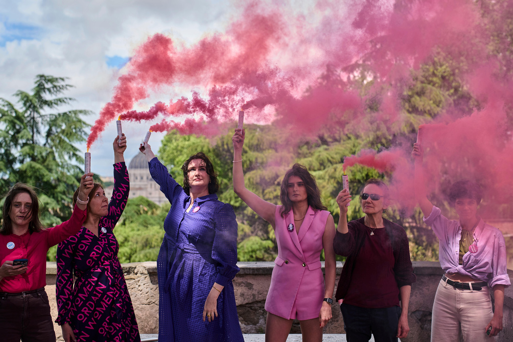 FILE - Activists from the Women's Ordination Conference release pink smoke to call for full equality for women in the Catholic Church on the first day of the conclave to elect the 267th pope, in Rome, May 7, 2025. (AP Photo/Bernat Armangue, file)