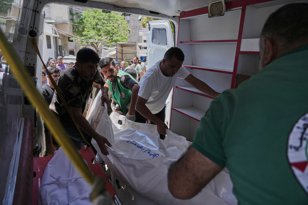 Palestinians carry the bodies of people killed in an Israeli strike, during their funeral in Shifa Hospital in Gaza City, Thursday, June 4, 2026. (AP Photo/Jehad Alshrafi)