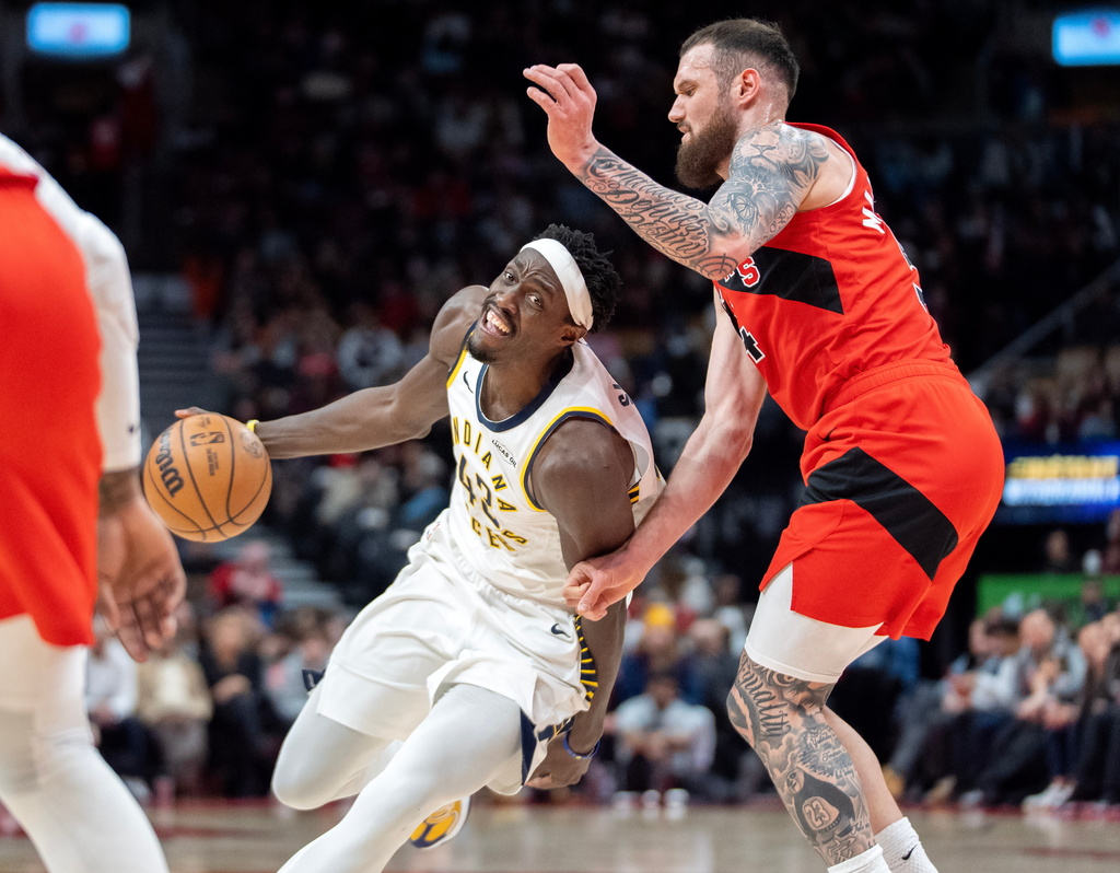 Indiana Pacers forward Pascal Siakam, left, drives past Toronto Raptors forward Sandro Mamukalashvili, right, during first-half NBA basketball game action in Toronto, Sunday Feb. 8, 2026. (Frank Gunn/The Canadian Press via AP)