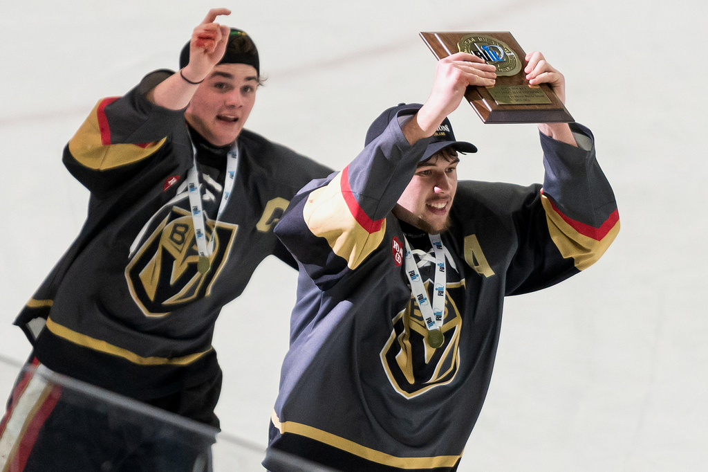 Blackstone Valley Schools team captain Colin Dorgan holds up the Rhode Island Division II state ice hockey championship trophy after defeating Lincoln High School, March 18, 2026, in Providence, R.I. (T.J. Auclair & Kyle Auclair/Little Big Leaguers Photography via AP)