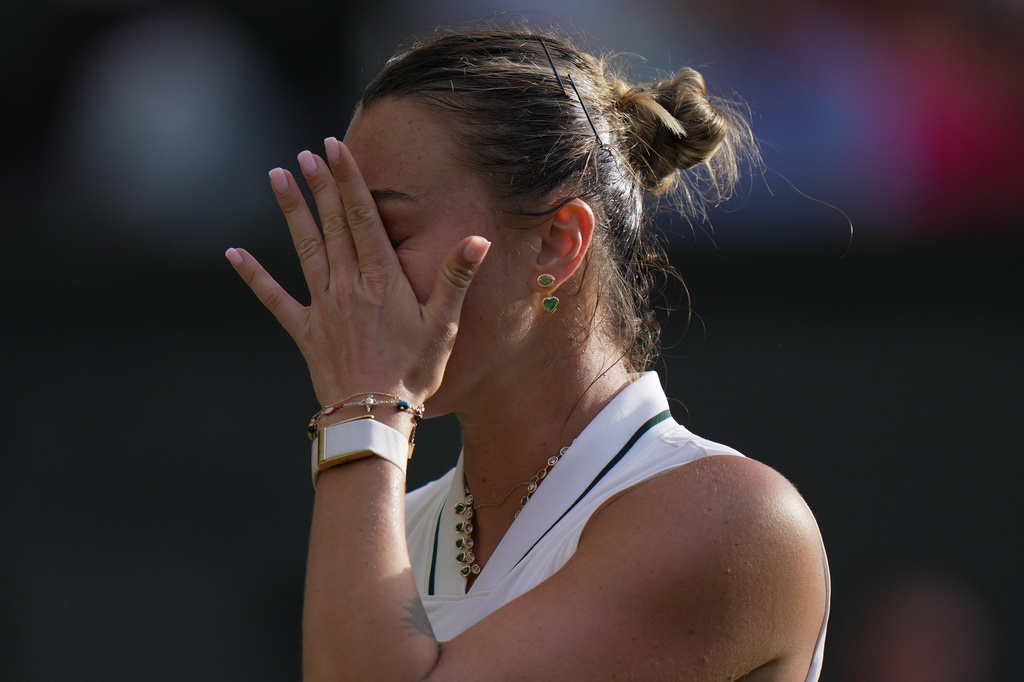Aryna Sabalenka of Belarus reacts to losing against Naomi Osaka of Japan in their fourth round women's singles match at the Wimbledon Tennis Championships in London, Sunday, July 5, 2026. (AP Photo/Brian Inganga)