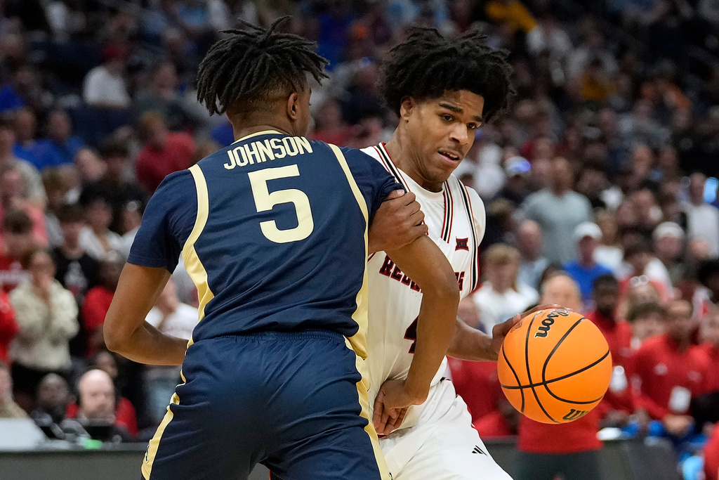 Texas Tech guard Christian Anderson (4) grabs ahold of Akron guard Tavari Johnson (5) as he tries to drive to the basket during the first half in the first round of the NCAA college basketball tournament Friday, March 20, 2026, in Tampa, Fla. (AP Photo/Chris O'Meara)