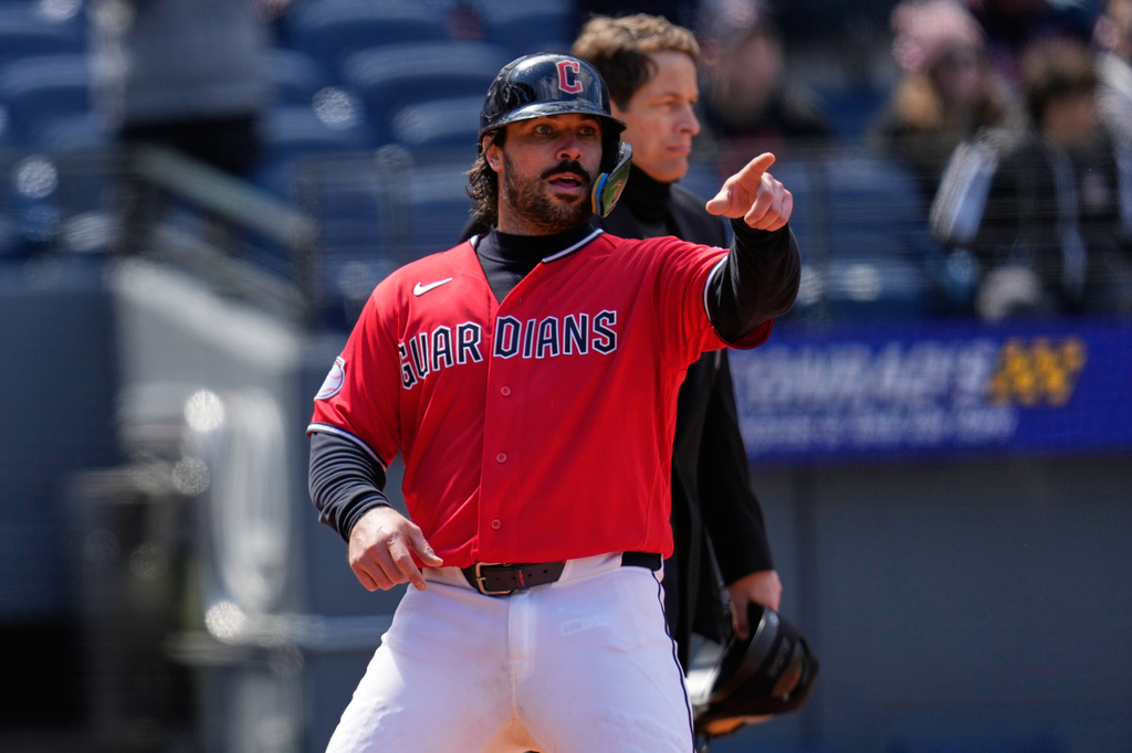 Cleveland Guardians' Austin Hedges gestures to first base as he scores on a single hit by Steven Kwan in the fifth inning of a baseball game against the Kansas City Royals in Cleveland, Tuesday, April 7, 2026. (AP Photo/Sue Ogrocki)