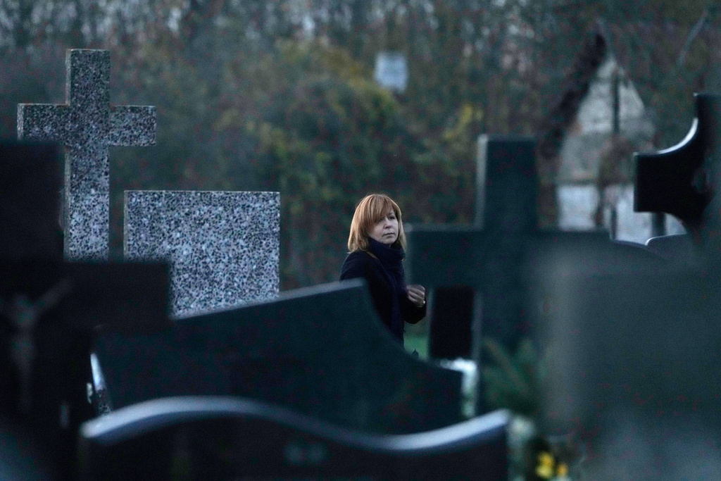 A women observe All Saints' Day, a time for reflecting on those who have died, in Kroczewo near Warsaw, Poland, Saturday, Nov. 1, 2025. (AP Photo/Czarek Sokolowski)Sokolowski)