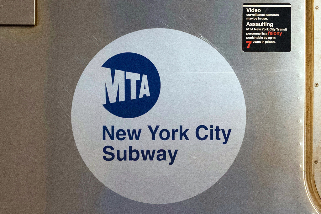 FILE - The MTA logo is seen on the side of a New York City subway car, April 23, 2020, in New York. (AP Photo/Mark Lennihan, File)