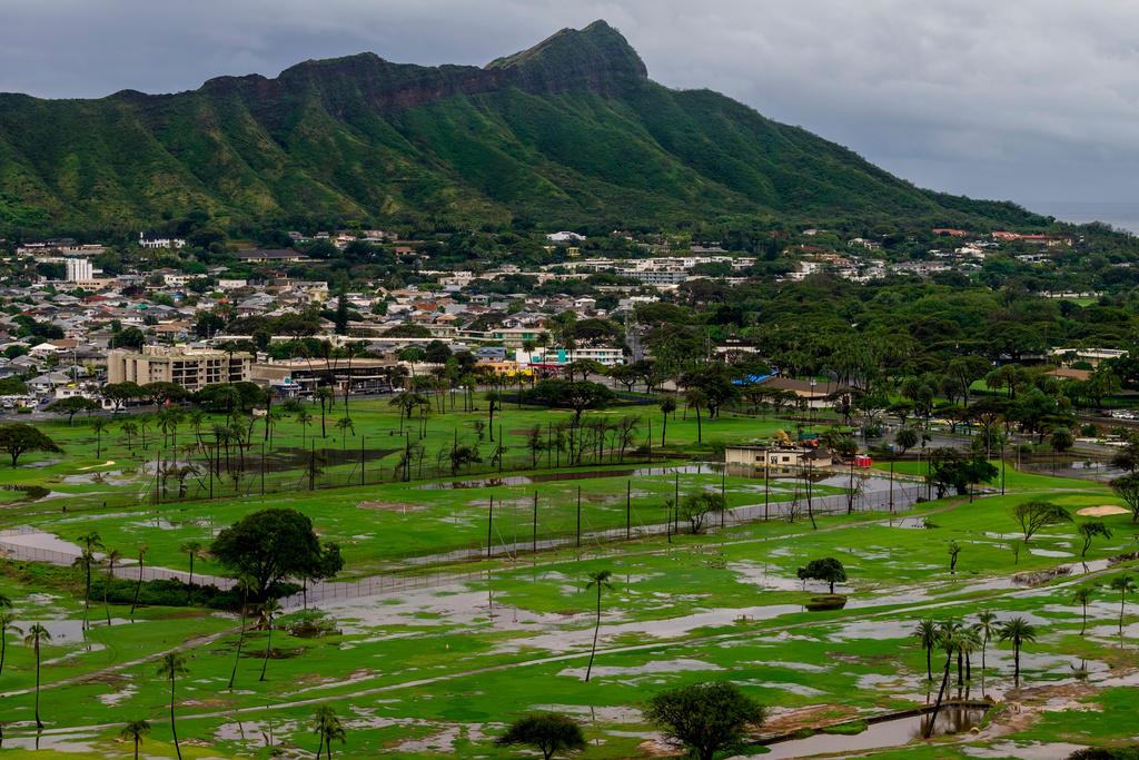 The Ala Wai Golf Course is seen inundated with water from the recent storms, as Hawaii residents work to recover from one of the worst floods in decades, in Waikiki, Hawaii, Sunday, March 22, 2026. (Stephen Lam/San Francisco Chronicle via AP)