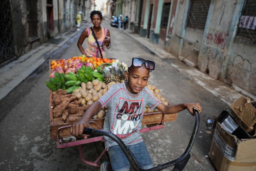 A boy drives a cart of vegetables for sale in Havana, Tuesday, Jan. 13, 2026. (AP Photo/Ramon Espinosa)