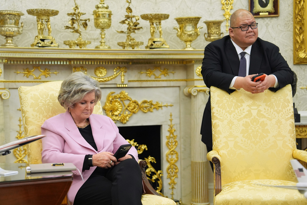 White House chief of staff Susie Wiles and White House communications director Steven Cheung listen as President Donald Trump talks after meeting with New York City Mayor-elect Zohran Mamdani in the Oval Office of the White House, Friday, Nov. 21, 2025, in Washington. (AP Photo/Evan Vucci)