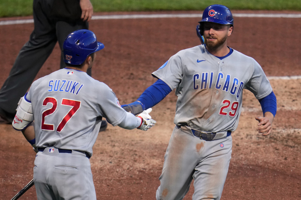 Chicago Cubs' Michael Busch (29) is greeted by Seiya Suzuki after scoring on a single by Ian Happ off Pittsburgh Pirates pitcher Paul Skenes during the sixth inning of a baseball game in Pittsburgh, Thursday, May 28, 2026. (AP Photo/Gene J. Puskar)