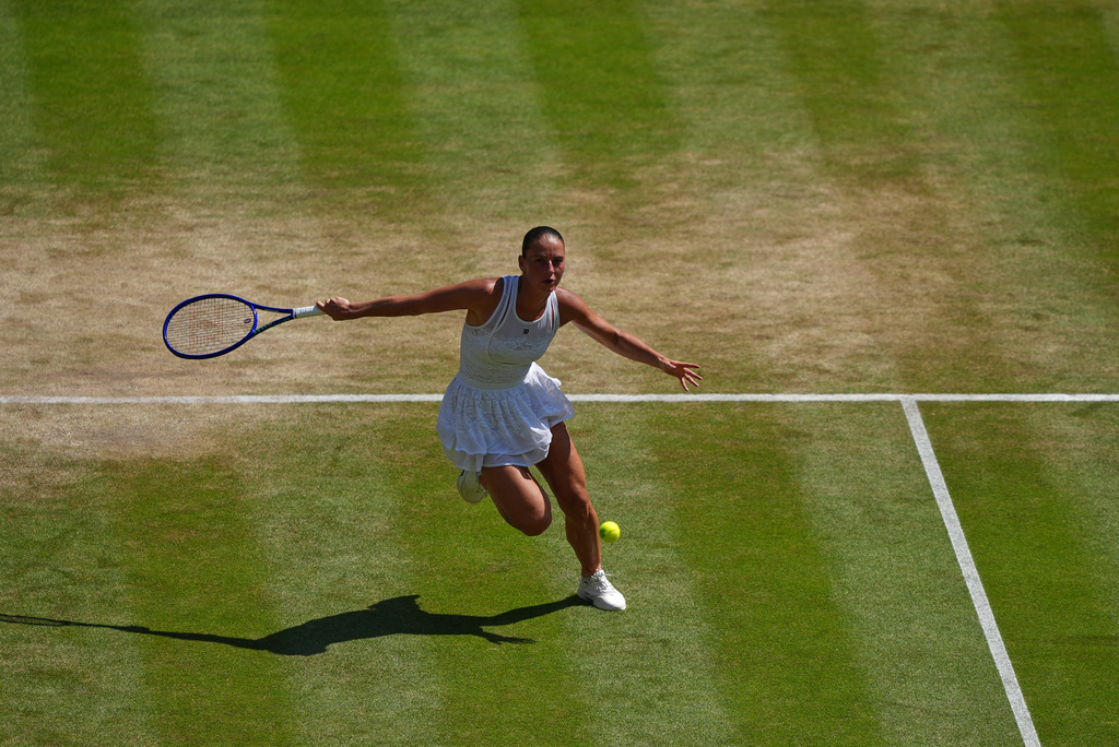Marta Kostyuk of Ukraine returns the ball to Jasmine Paolini of Italy in their quarter-final women's singles match at the Wimbledon Tennis Championships in London, Wednesday, July 8, 2026. (AP Photo/Maja Smiejkowska)