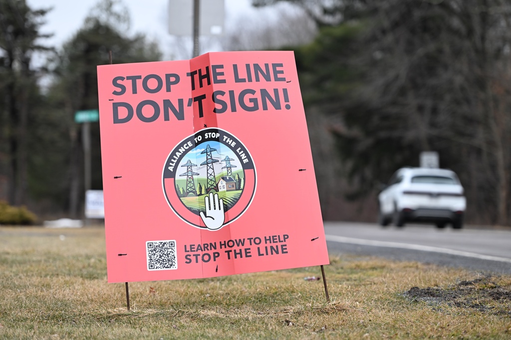 A sign protesting the local power utility's plan to build a 500-kilovolt power line nearby on towers as tall as 240 feet, March 4, 2026, in Sugarloaf, Pa. (AP Photo/Marc Levy)