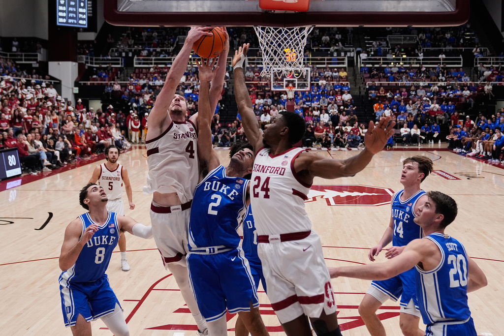 Stanford forward AJ Rohosy (4) rebounds the ball next to Duke guard Cayden Boozer (2) during the second half of an NCAA college basketball game, Saturday, Jan. 17, 2026, in Stanford, Calif. (AP Photo/Godofredo A. Vásquez)