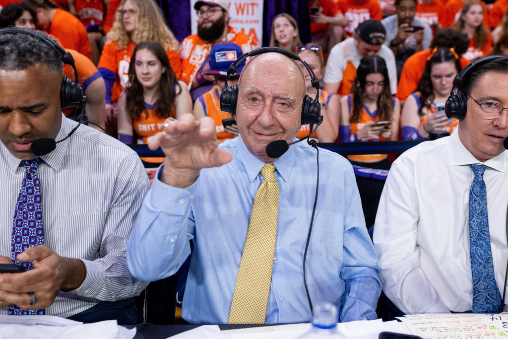 FILE - Dick Vitale, center, gives a wave during the second half of an NCAA college basketball game Feb. 8, 2025, in Clemson, S.C. (AP Photo/Scott Kinser, File)
