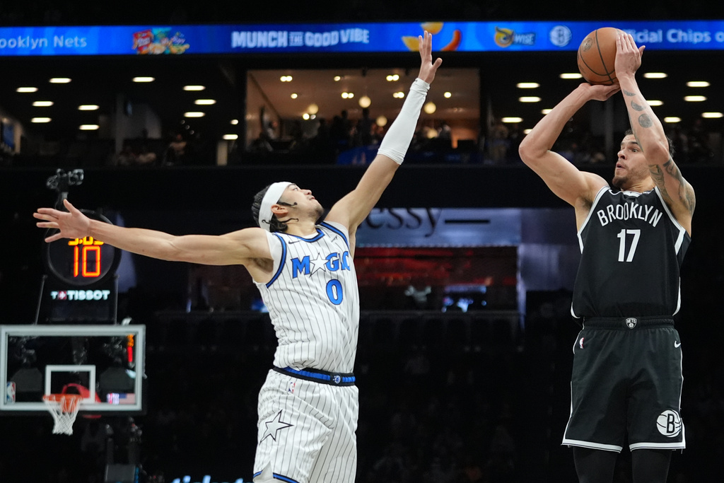Brooklyn Nets' Michael Porter Jr. (17) shoots over Orlando Magic's Anthony Black (0) during the first half of an NBA basketball game Wednesday, Jan. 7, 2026, in New York. (AP Photo/Frank Franklin II)