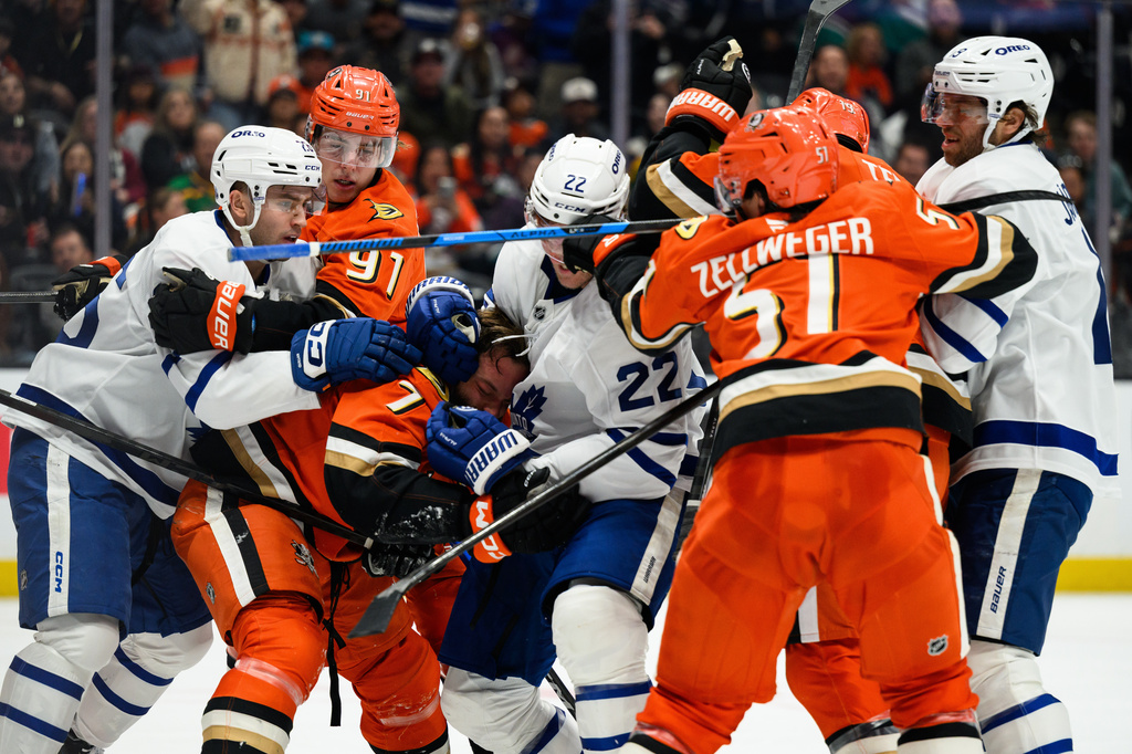 Anaheim Ducks and Toronto Maple Leafs players clash during the second period of an NHL hockey game Monday, March 30, 2026, in Anaheim, Calif. (AP Photo/William Liang)