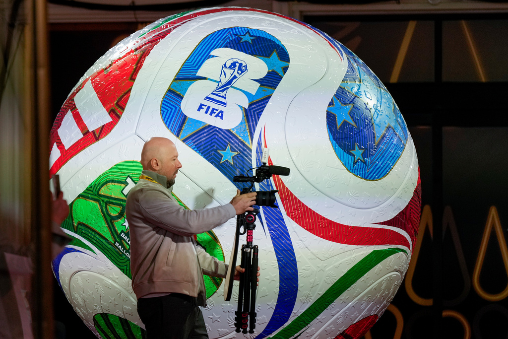 A member of the media works prior to the final draw for the 2026 soccer World Cup at the Kennedy Center in Washington, Thursday, Dec. 4, 2025. (AP Photo/Chris Carlson)