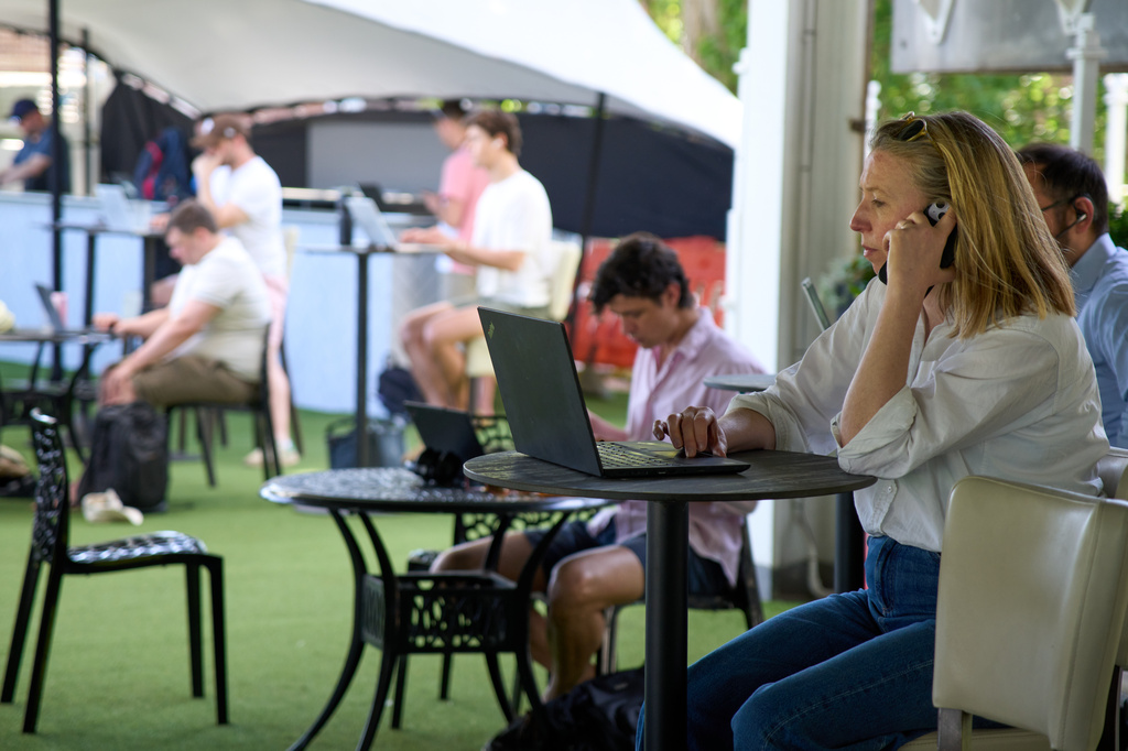 People work on their laptops during a Surrey against Sussex County Championship cricket match at the Kia Oval in London, Friday, May 1, 2026. (AP Photo/Tony Hicks)