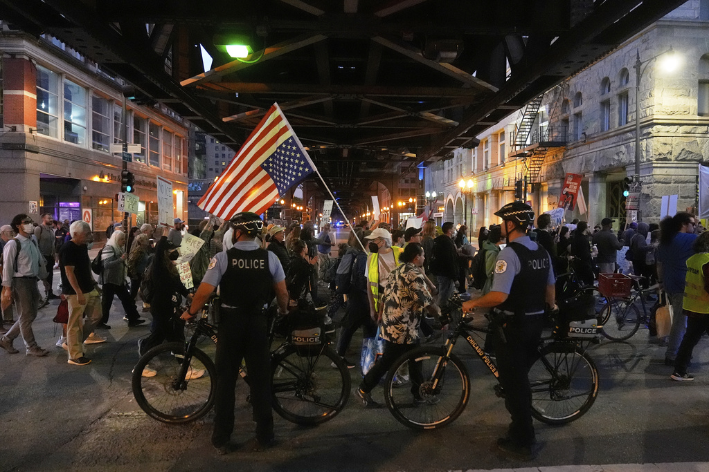 Police officers block a street as demonstrators march at a protest opposing "Operation Midway Blitz" and the presence of ICE, Tuesday, Sept. 9, 2025, in Chicago. (AP Photo/Erin Hooley)