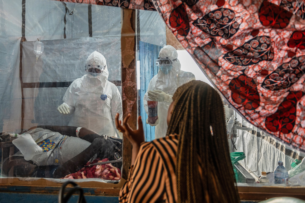 Health workers attend to an Ebola patient at the Rwampara treatment Center in Ituri, Congo, Thursday, June 18, 2026. (AP Photo/Moses Sawasawa)