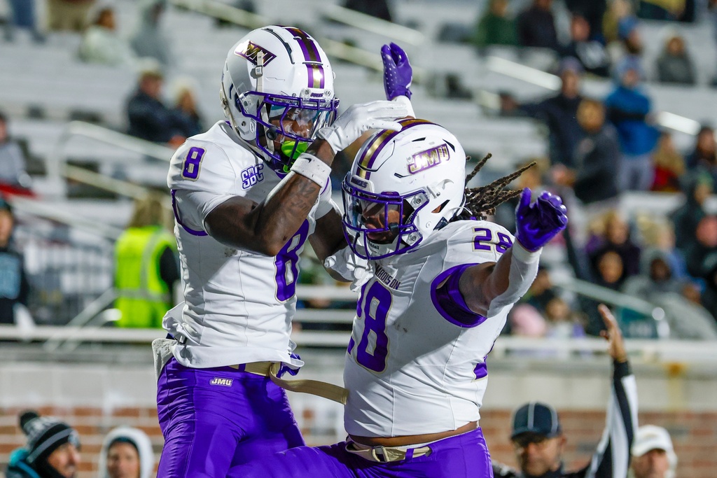 James Madison wide receiver Isaiah Alston (8) celebrates with running back Jobi Malary, right, after catching a touchdown pass against Coastal Carolina during the second half of an NCAA college football game in Conway, S.C., Saturday, Nov. 29, 2025. (AP Photo/Nell Redmond)