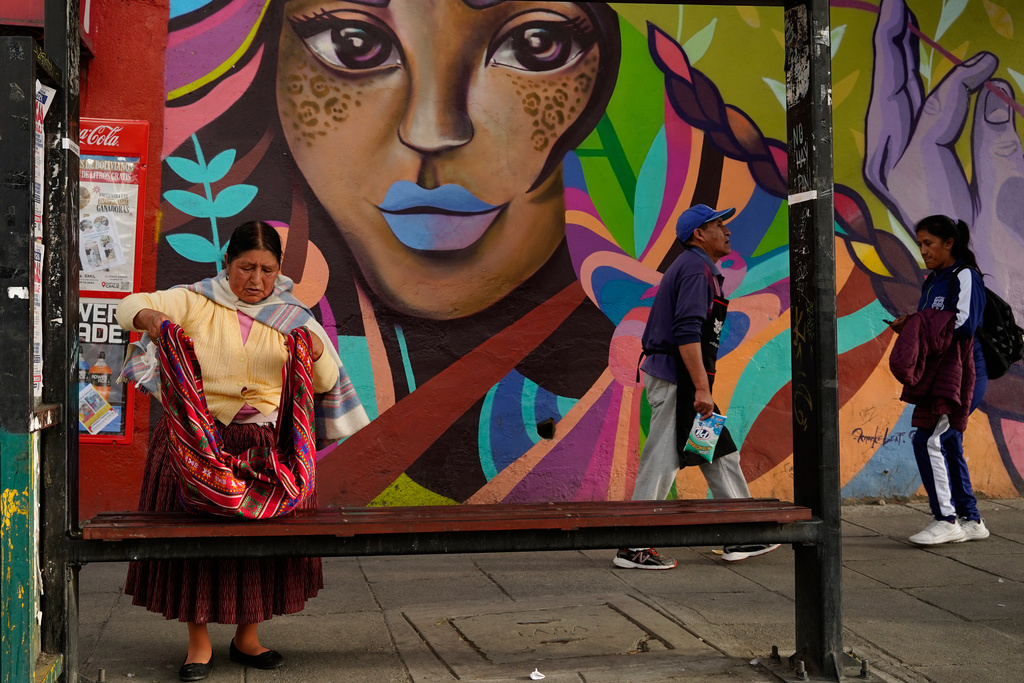 People walk during strike by the public transportation sector in La Paz, Bolivia, Friday, Dec. 19, 2025, after President Rodrigo Paz announced the end of fuel subsidies. (AP Photo/Freddy Barragan)