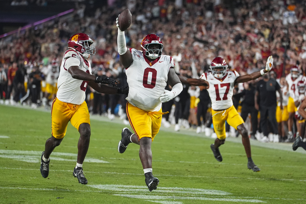 Southern California defensive tackle Jamaal Jarrett (0) celebrates as he returns an interception for a touchdown against Purdue during the second half of an NCAA college football game in West Lafayette, Ind., Saturday, Sept. 13, 2025. (AP Photo/Michael Conroy)