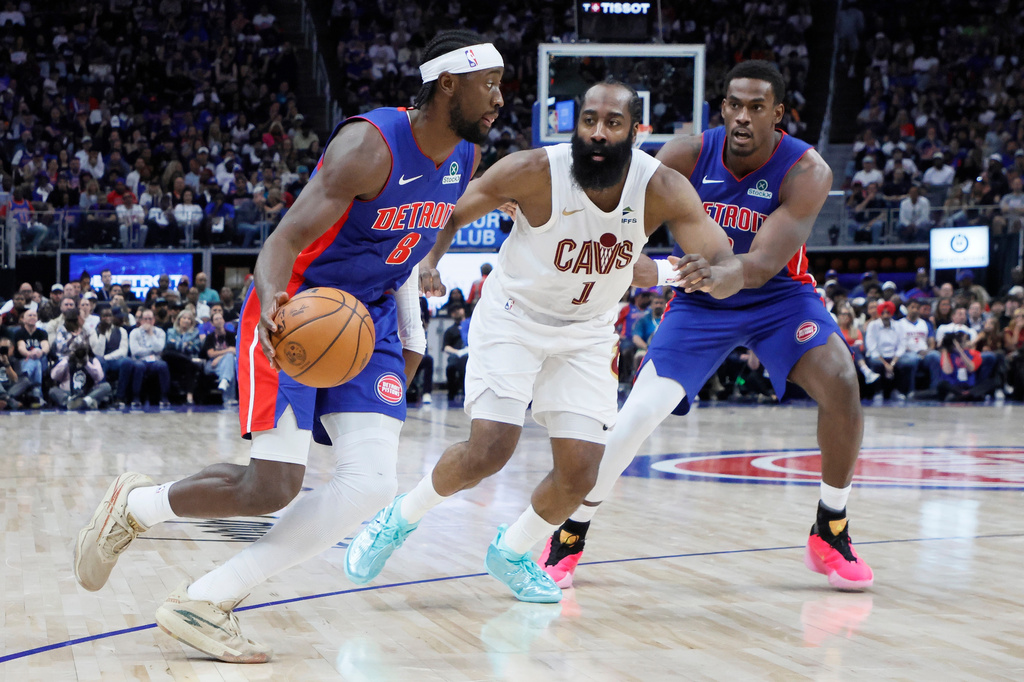 Detroit Pistons guard Caris LeVert (8) drives to the basket against Cleveland Cavaliers guard James Harden (1) with Pistons center Jalen Duren, right, helping on the play during the first half in Game 7 of a second-round NBA playoffs basketball series Sunday, May 17, 2026, in Detroit. (AP Photo/Duane Burleson)