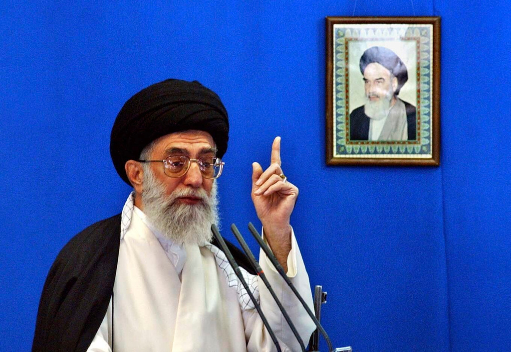 FILE — Iranian Supreme Leader Ayatollah Ali Khamenei, delivers his Friday prayer sermon, in front of a picture of the late revolutionary founder Ayatollah Khomeini, at the Tehran University campus in Tehran, Iran, Nov. 5, 2004. (AP Photo/Vahid Salemi, File)