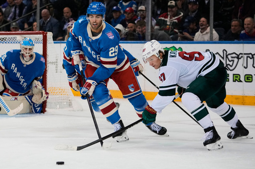 Minnesota Wild's Kirill Kaprizov (97) fights for control of the puck with New York Rangers' Matthew Robertson (29) during the second period of an NHL hockey game Monday, Oct. 20, 2025, at Madison Square Garden in New York. (AP Photo/Frank Franklin II) Minnesota Wild's Kirill Kaprizov (97) fights for control of the puck with New York Rangers' Matthew Robertson (29) during the second period of an NHL hockey game Monday, Oct. 20, 2025, at Madison Square Garden in New York. (AP Photo/Frank Franklin II)