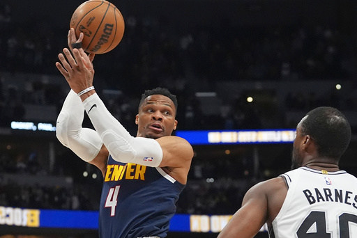 FILE - Denver Nuggets guard Russell Westbrook, left, passes the ball over San Antonio Spurs forward Harrison Barnes in the first half of an NBA basketball game Wednesday, April 2, 2025, in Denver. (AP Photo/David Zalubowski, File) FILE - Denver Nuggets guard Russell Westbrook, left, passes the ball over San Antonio Spurs forward Harrison Barnes in the first half of an NBA basketball game Wednesday, April 2, 2025, in Denver. (AP Photo/David Zalubowski, File)