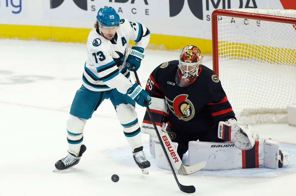San Jose Sharks' Tyler Toffoli (73) tips the puck past Ottawa Senators' goaltender Linus Ullmark (35) during first period NHL hockey action in Ottawa on Sunday, March 15, 2026. (Patrick Doyle/The Canadian Press via AP)