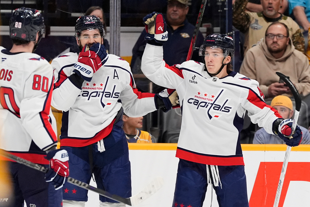 Washington Capitals defenseman Cole Hutson, right, celebrates his goal with right wing Tom Wilson (43) and center Pierre-Luc Dubois (80) during the first period of an NHL hockey game against the Nashville Predators, Thursday, Oct. 29, 2026, in Nashville, Tenn. (AP Photo/George Walker IV)