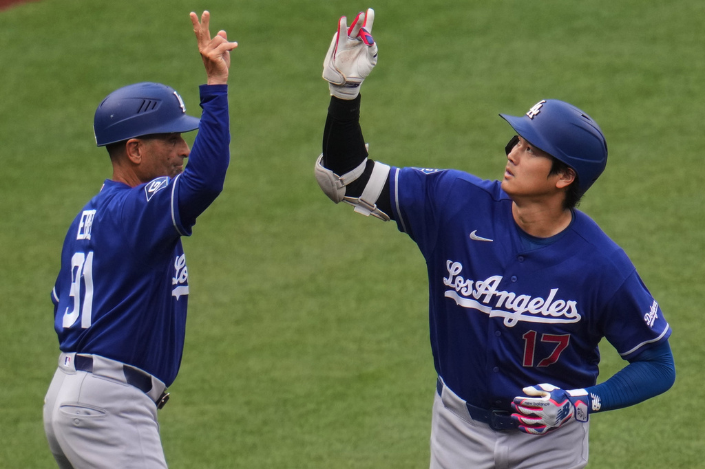 Los Angeles Dodgers' Shohei Ohtani (17) celebrates with third base coach Dino Ebel, left, as he rounds third base after hitting a solo home run off Pittsburgh Pirates pitcher Mitch Keller during the third inning of a baseball game in Pittsburgh, Thursday, June 11, 2026. (AP Photo/Gene J. Puskar)