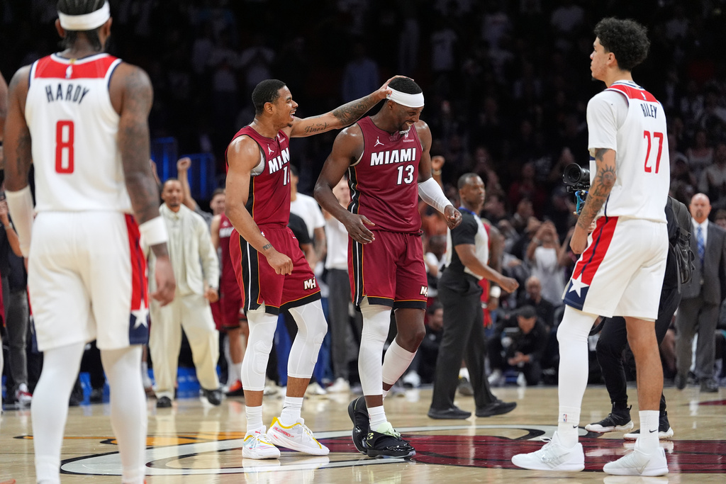 Miami Heat center Bam Adebayo (13) is congratulated by forward Keshad Johnson (16) after reaching 83 points, the second-highest single game total in NBA history, in the second half of an NBA basketball game against the Washington Wizards, Tuesday, March 10, 2026, in Miami. (AP Photo/Rebecca Blackwell)