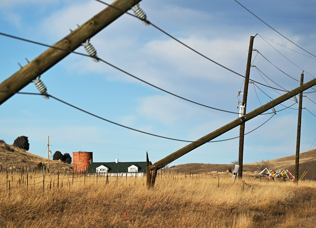 Power poles along U.S. Highway 93 near Golden, Colo., snapped in half during a strong wind storm on Wednesday, Dec. 17, 2025. (Photo by RJ Sangosti/The Denver Post via AP)