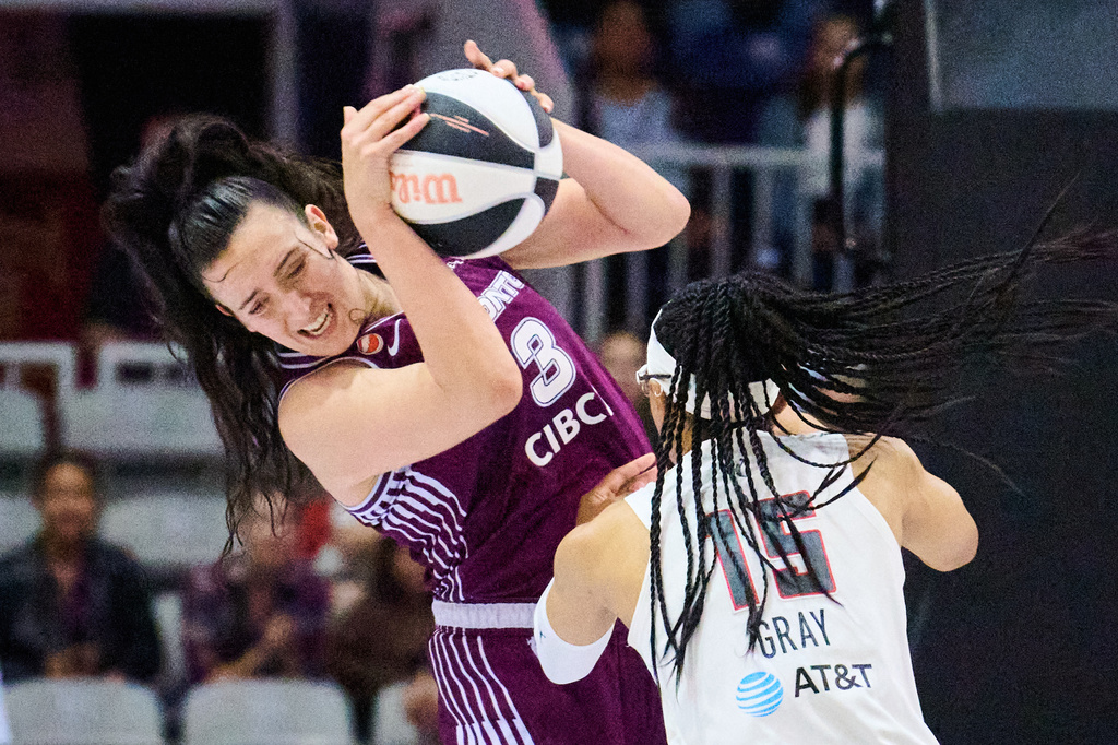 Toronto Tempo's Marina Mabrey (3) and Atlanta Dream's Allisha Gray (15) battle for the ball during the first half of a WNBA basketball game in Toronto, Sunday, June 14, 2026. (Sammy Kogan/The Canadian Press via AP)
