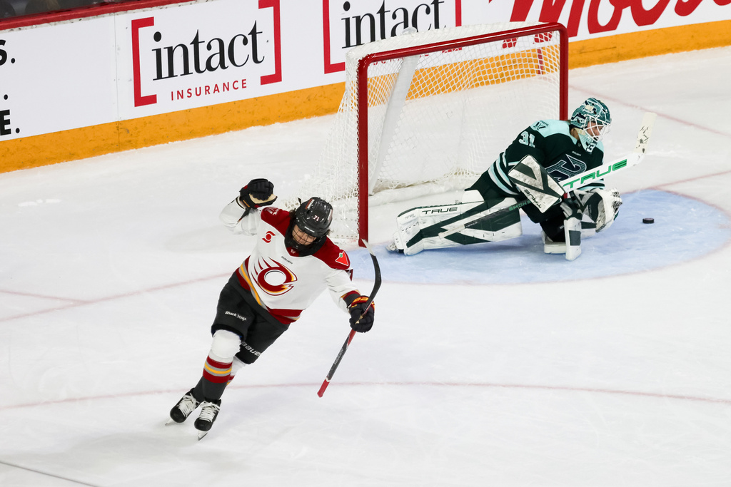 Ottawa Charge's Fanuza Kadirova, left, reacts after scoring in the shootout against Boston Fleet goaltender Aerin Frankel, right, during a PWHL hockey game in Halifax, Nova Scotia, Sunday, Jan. 11, 2025. (Riley Smith/The Canadian Press via AP)