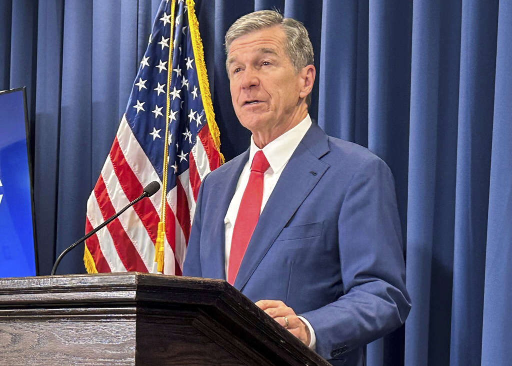 FILE - North Carolina Gov. Roy Cooper unveils a report during a press conference in Raleigh, N.C., Oct. 23, 2024. (AP Photo/Gary D. Robertson, File)
